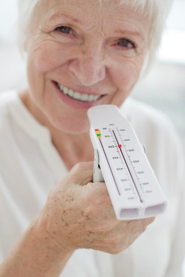 Senior Woman Holding Peak Flow Metre Photograph by Science Photo Library