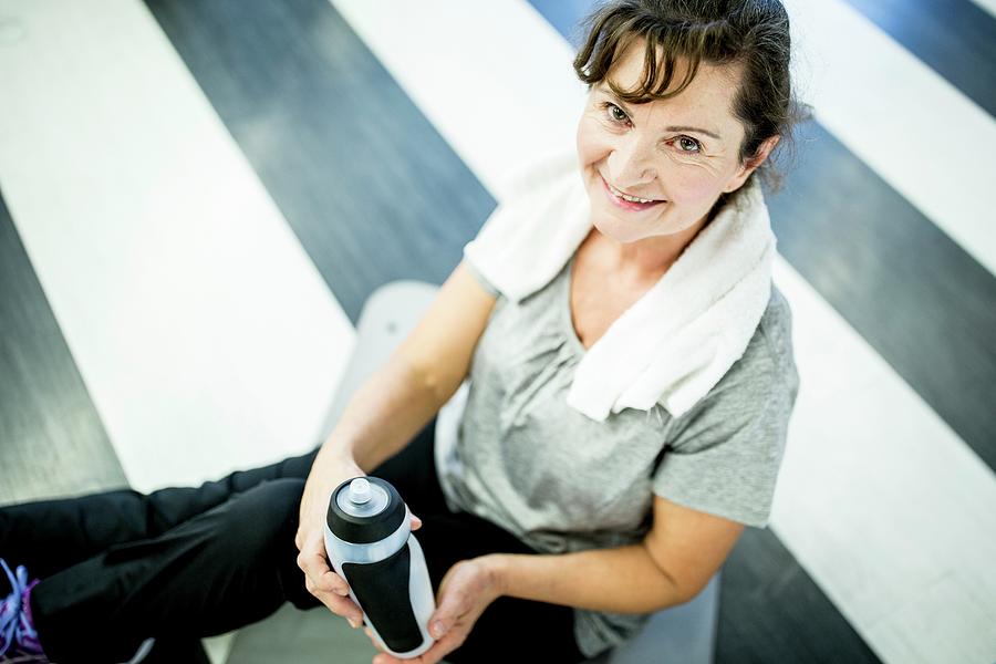 Senior Woman Holding Water Bottle Photograph by Science Photo Library