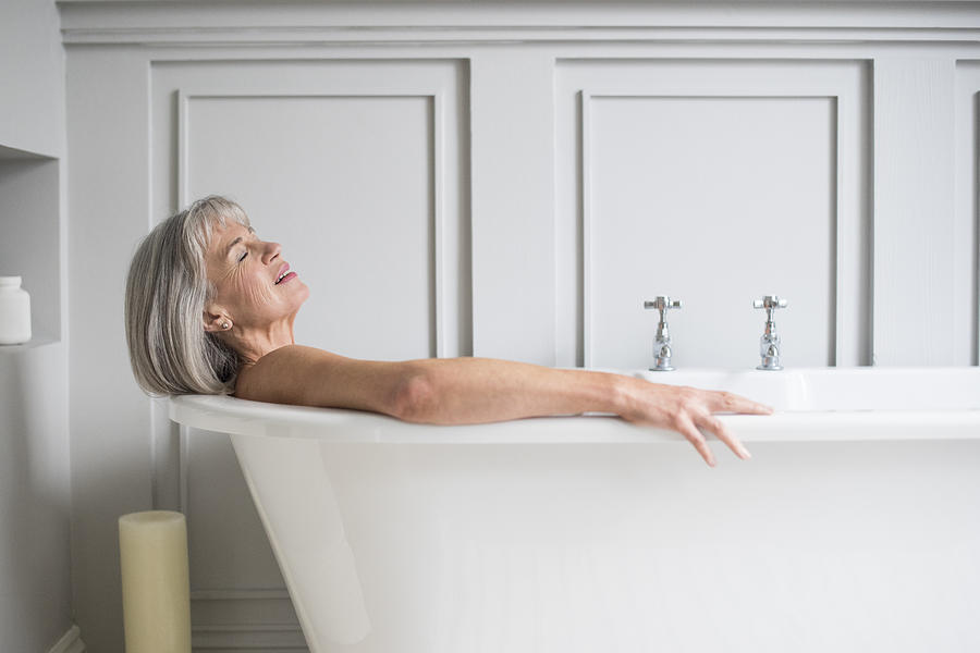 Senior woman relaxing in bath with eyes closed Photograph by JohnnyGreig