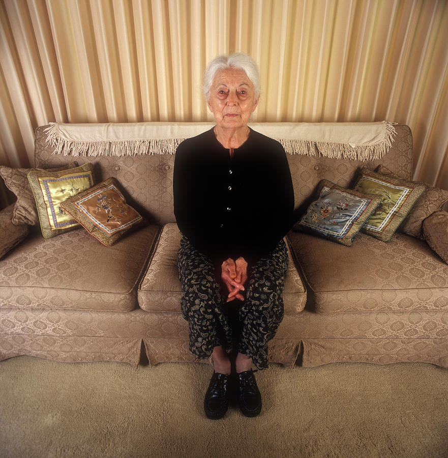 Portrait Photograph - Senior Woman Sitting On A Couch by Ron Koeberer