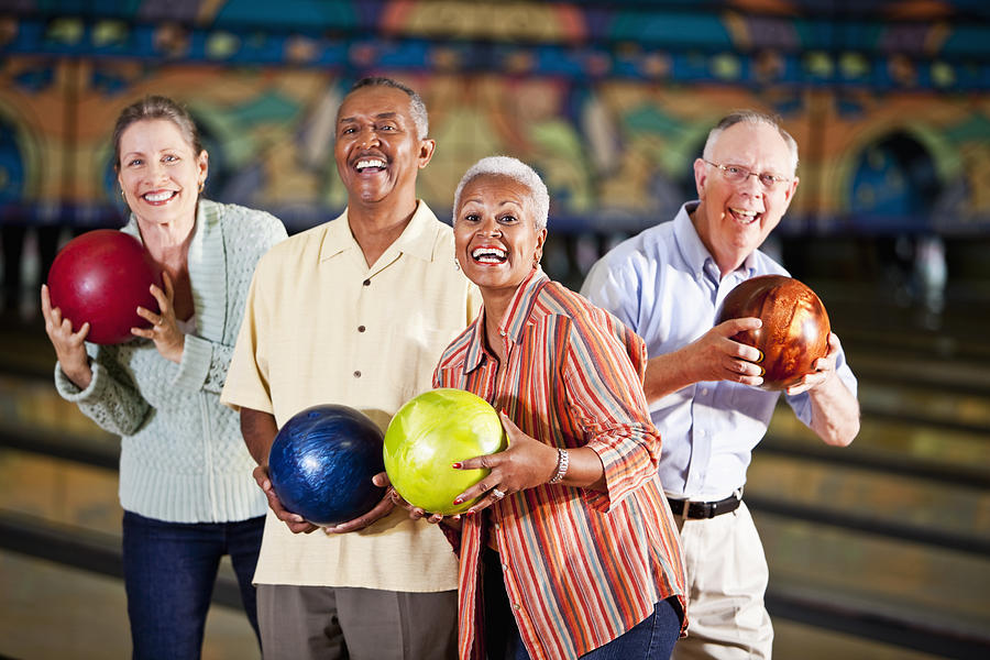 Seniors at bowling alley Photograph by Kali9