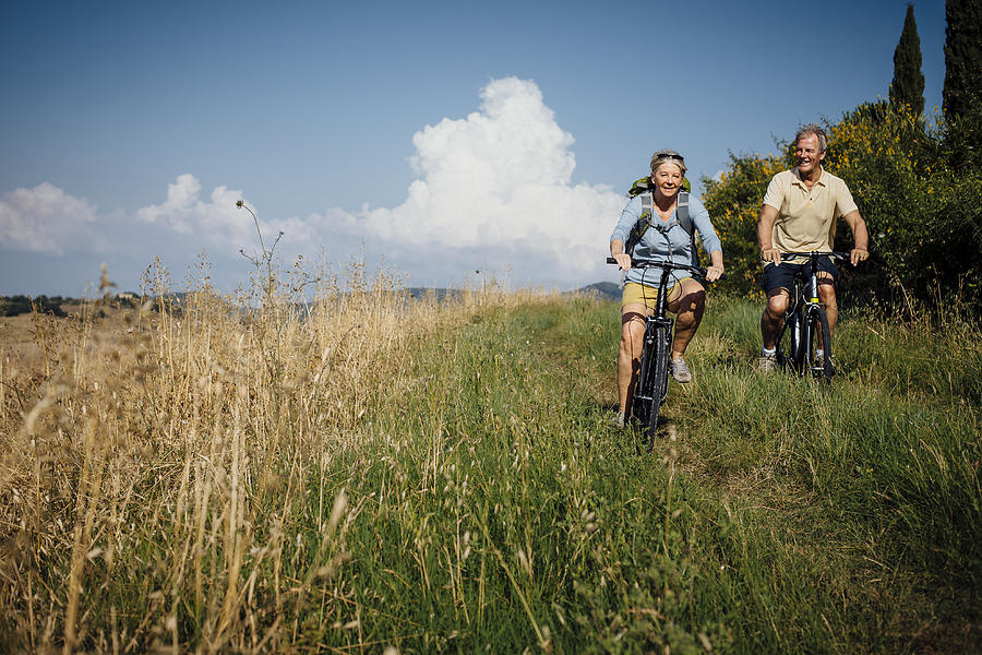 Seniors on Mountain Bikes in the Countryside Photograph by SolStock
