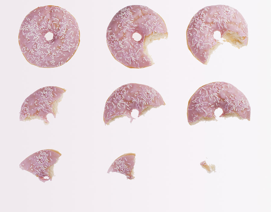 Sequence of bites taken from pink donut Photograph by Robert Daly