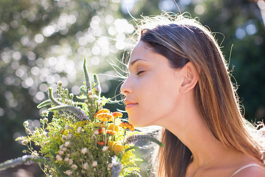 Serene woman smelling bouquet Photograph by Tom Merton
