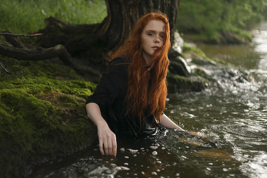 Serious Caucasian woman standing waist deep in water Photograph by Dmitriy Bilous