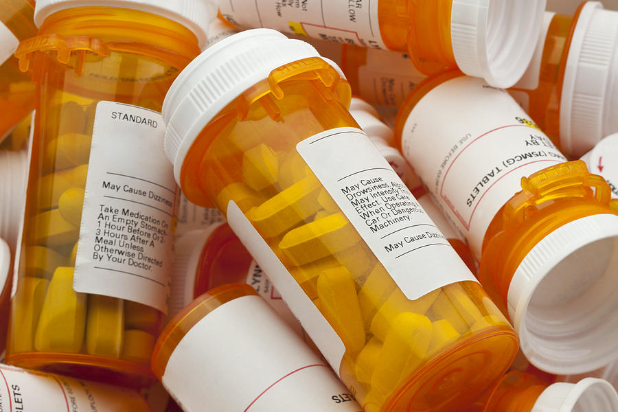 Several Prescription Pill Bottles in a Pile Photograph by Smartstock