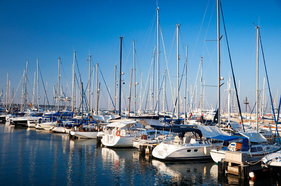 Several yachts docked at the harbor Photograph by Kuklev