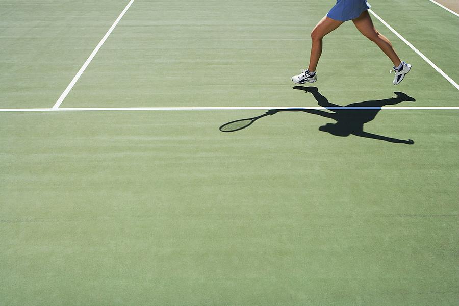 Shadow and legs of person playing tennis Photograph by FangXiaNuo
