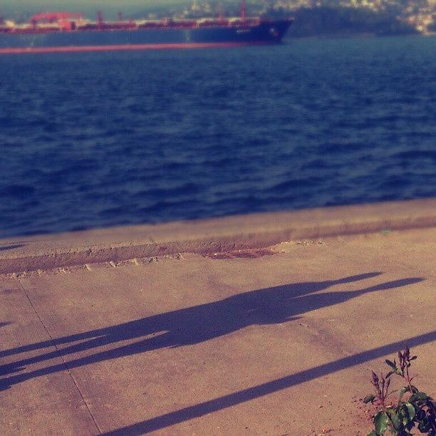 Shadow By The Sea Side Photograph by Yasin Celikmakas