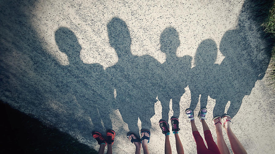 Shadows on a gravel path of a family of five Photograph by Elva Etienne