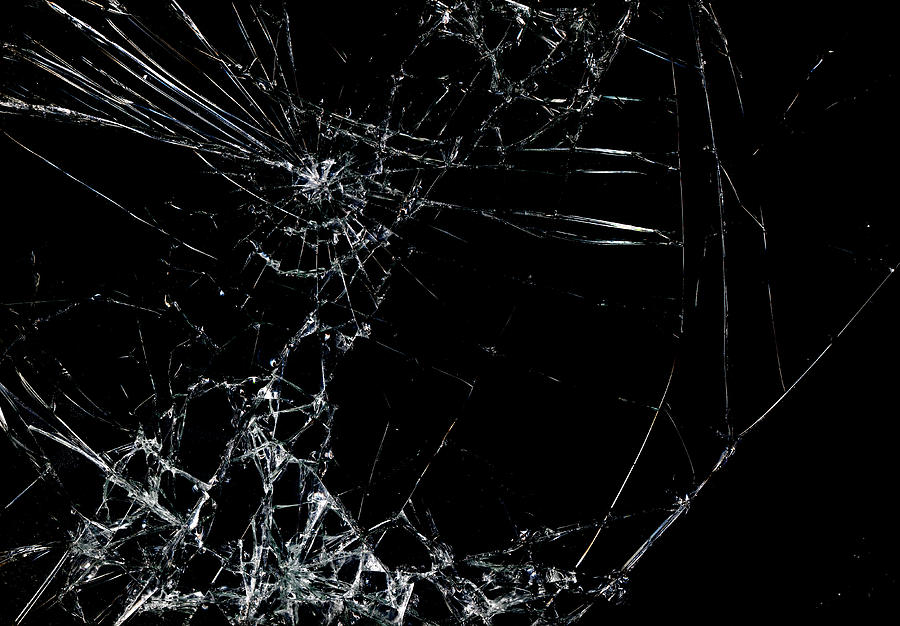 Shattered glass in dark background Photograph by Belterz