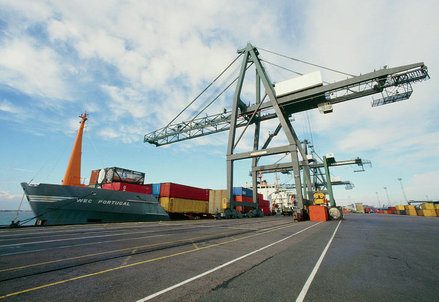 Ship And Dockside Cranes At A Container Port Photograph by David Guyon/science Photo Library