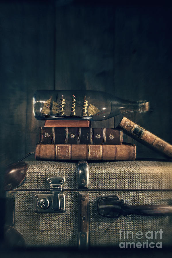 Ship in a bottle and books on suitscase Photograph by Sandra Cunningham