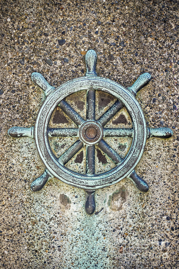 Ships steering wheel decoration on concrete wall Photograph by Bryan Mullennix