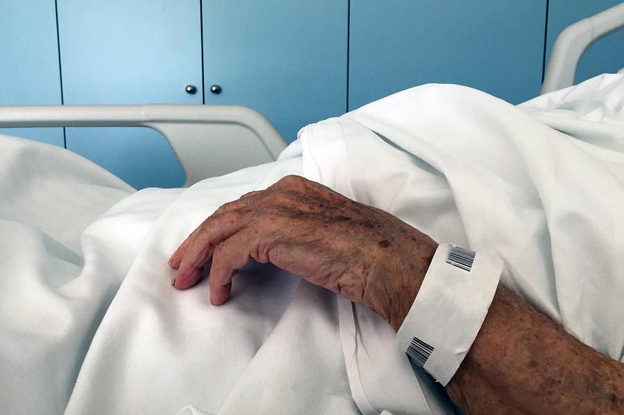 Sick old woman in a bed Photograph by Fernando Trabanco Fotografía