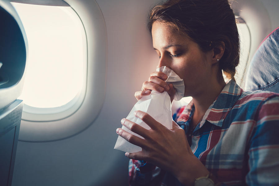Sick woman with nausea in the airplane Photograph by Martin-dm