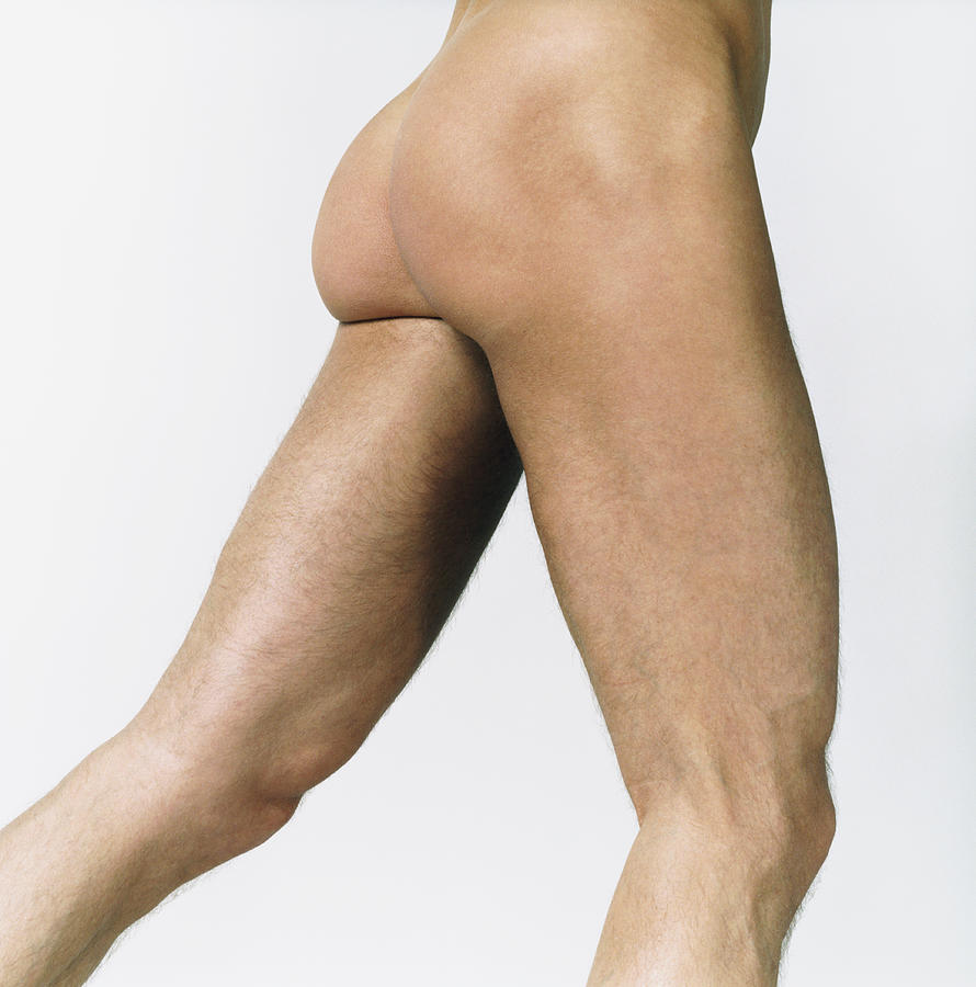 Side View of a Naked Mans Thighs Photograph by Digital Vision.