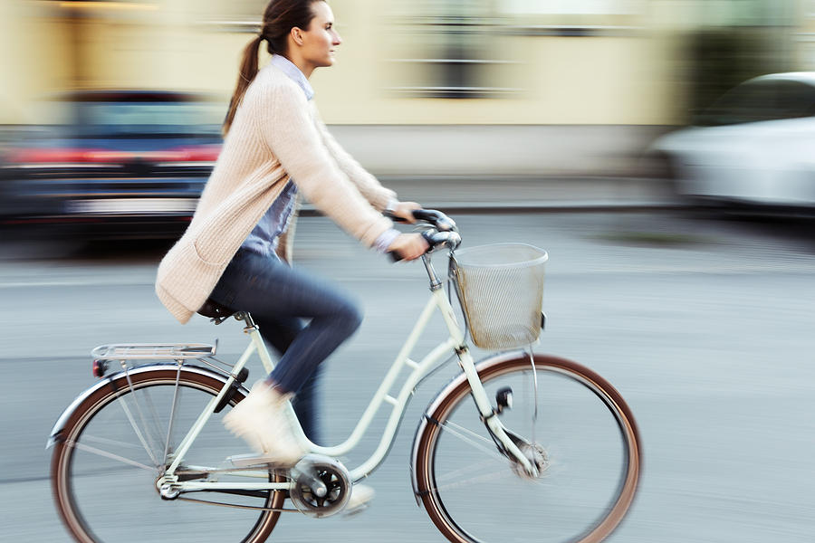 Side view of businesswoman riding bicycle on road Photograph by Kentaroo Tryman