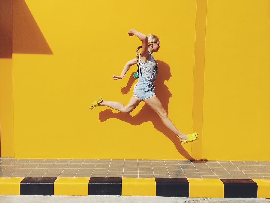 Side View Of Mid Adult Woman Jumping On Footpath Against Yellow Wall Photograph by Mikhail Novozilov / EyeEm Side View Of Mid Adult Woman Jumping On Footpath Against Yellow Wall Photograph by Mikhail Novozilov / EyeEm