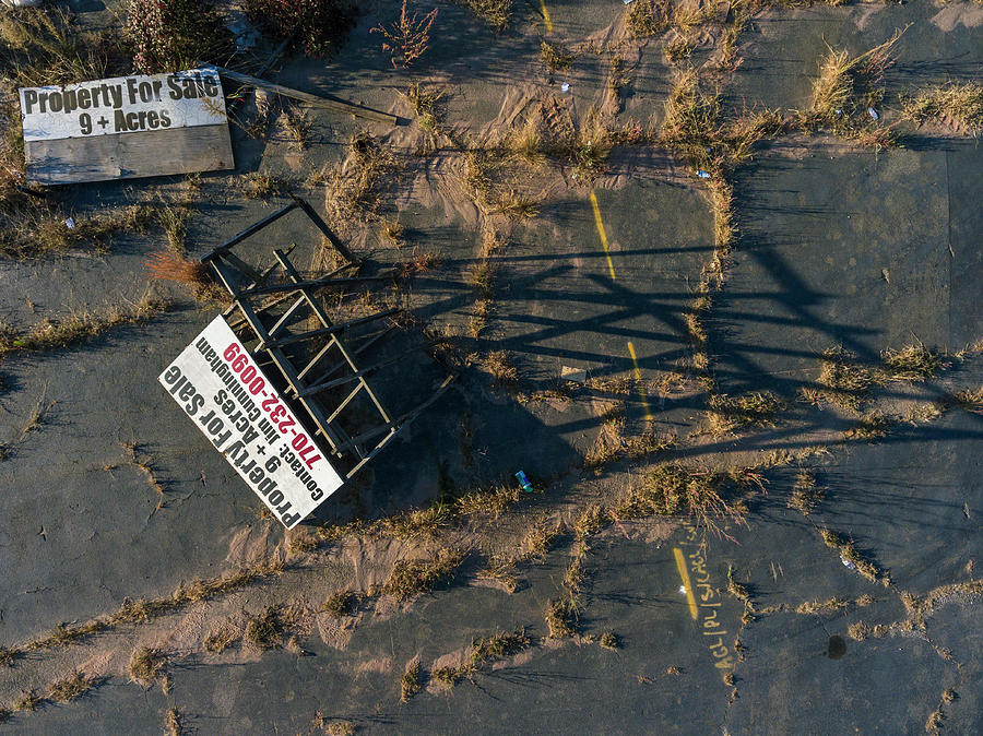 signs-on-abandoned-parking-lot-photograph-by-peter-essick-pixels