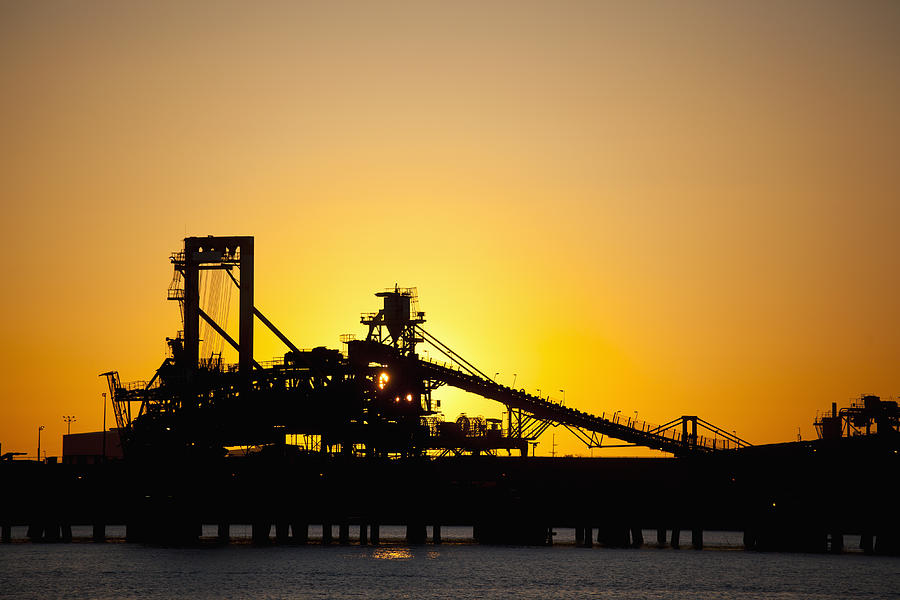 Silhouette of a bucket wheel reclaimer at an iron ore mine Photograph by Tobias Titz