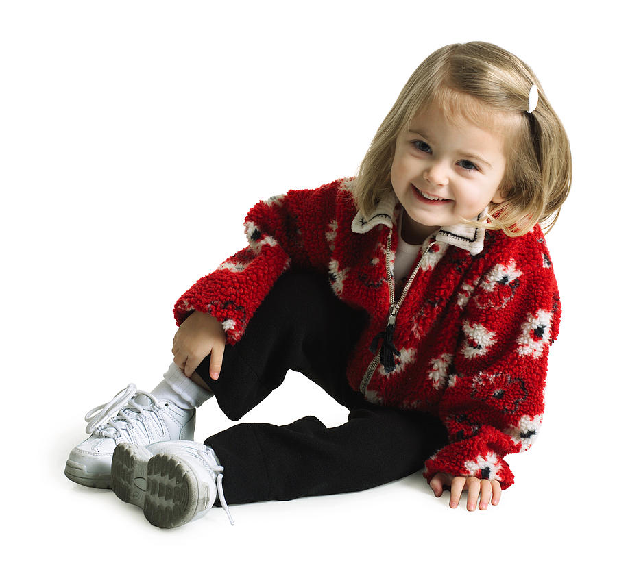 Silhouette Of A Cute Caucasian Female Child In Black Pants And A Red Sweater As She Sits And Smiles Photograph by Photodisc