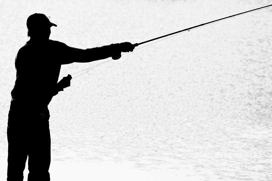 Silhouette of a Fisherman Holding a Fishing Pole BW Photograph by