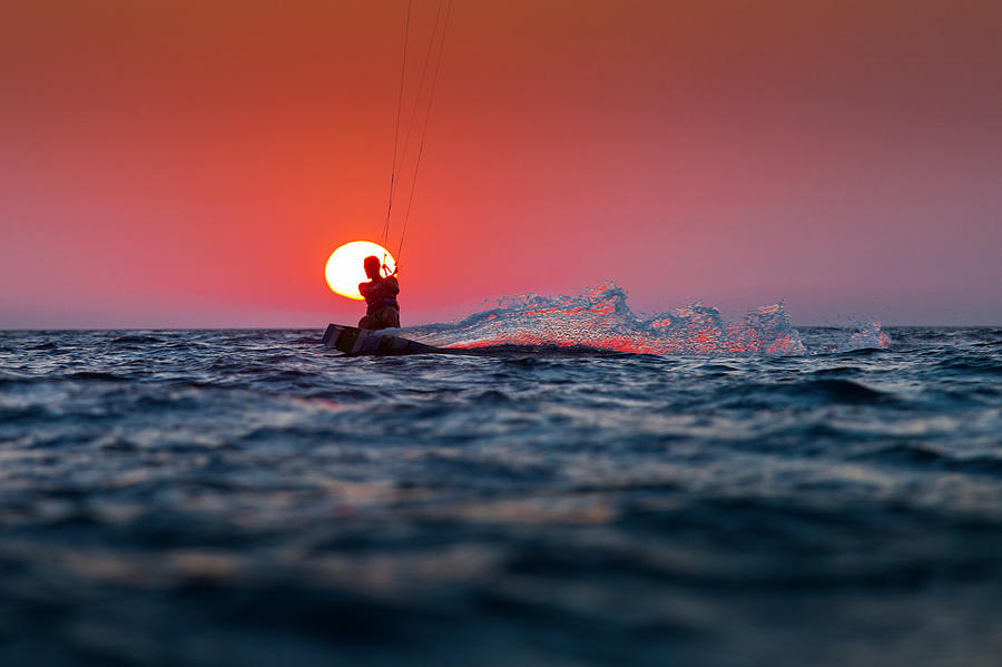Summer Photograph - Silhouette of a kitesurfer sailing at sunset by Dan Mirica