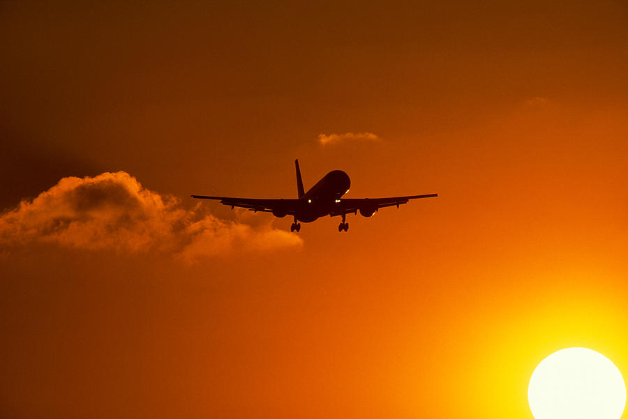 Sunset Photograph - Silhouette Of Airliner In Golden Sunset by Panoramic Images