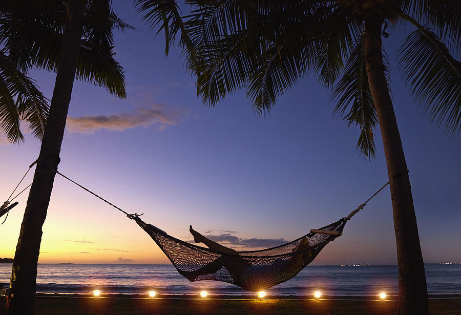 Silhouette of Caucasian woman relaxing in hammock at sunset Photograph by Colin Anderson Productions pty ltd