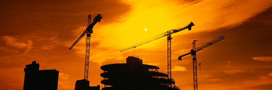 Silhouette Of Cranes At A Construction Photograph by Panoramic Images