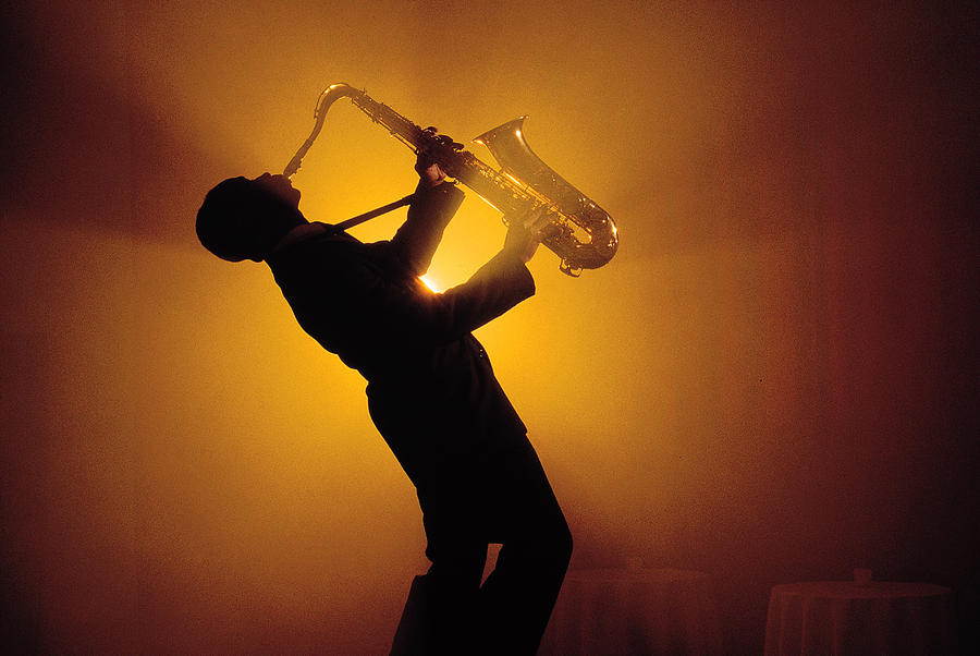 Silhouette of man playing saxophone Photograph by Comstock