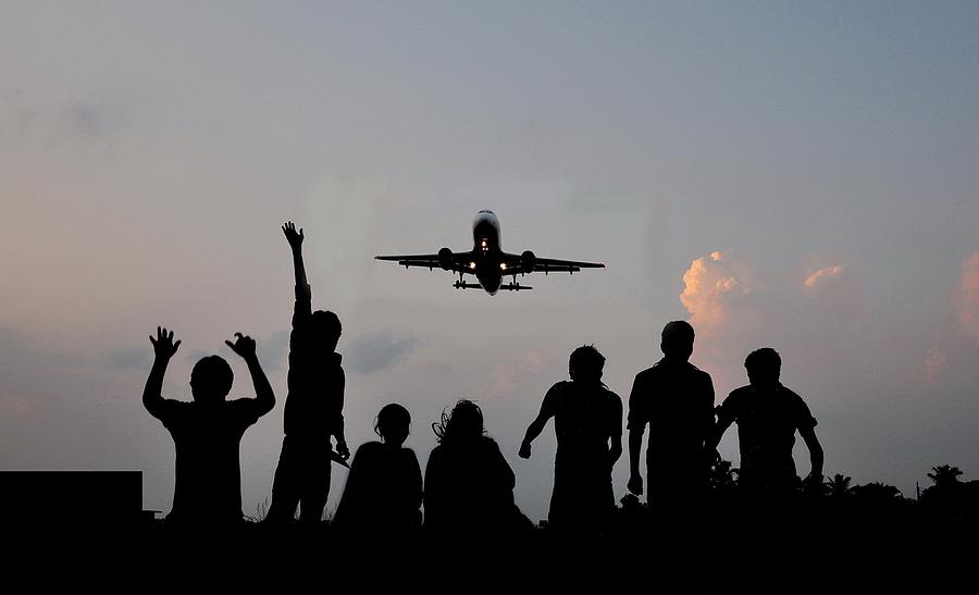 Silhouette of people watching flying plane Photograph by SaBBiR Photography