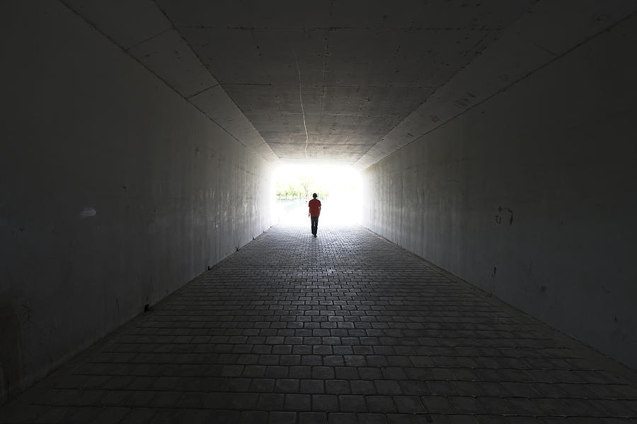 silhouette of person walking out of  a tunnel. Light at End of Tunnel Photograph by Yaorusheng