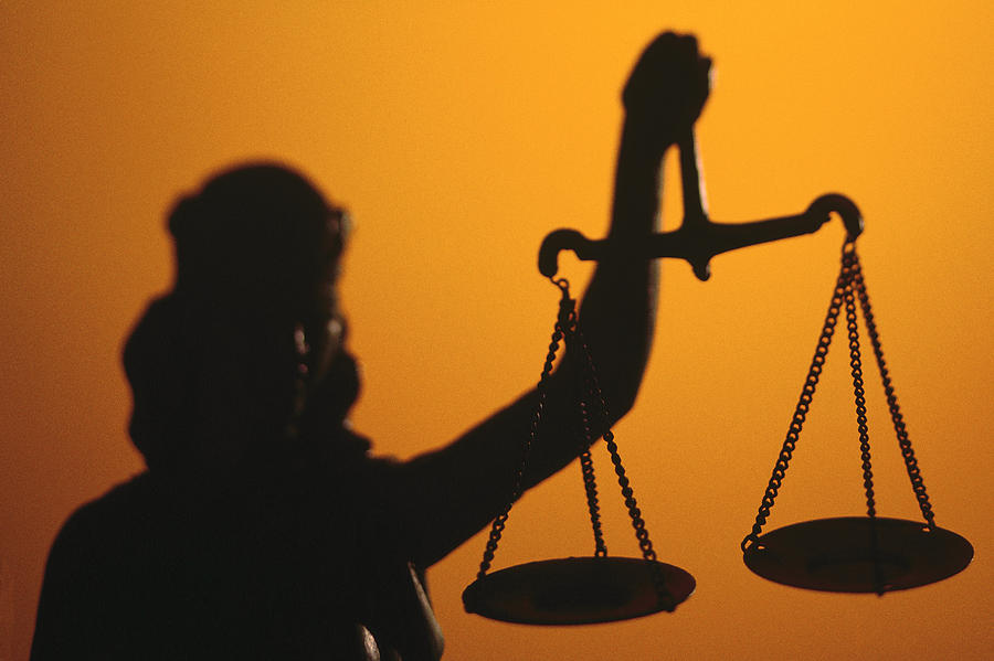 Silhouette of scales of Lady Justice holding scales Photograph by Comstock
