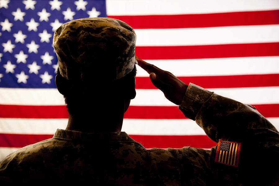 Silhouette of soldier saluting the American flag Photograph by Fstop123