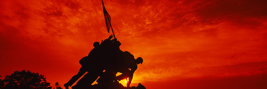 Sunset Photograph - Silhouette Of Statues At A War by Panoramic Images