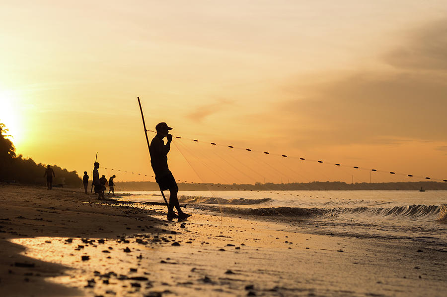 Silhouette Of Vietnamese Fishermen Photograph by Miha Pavlin