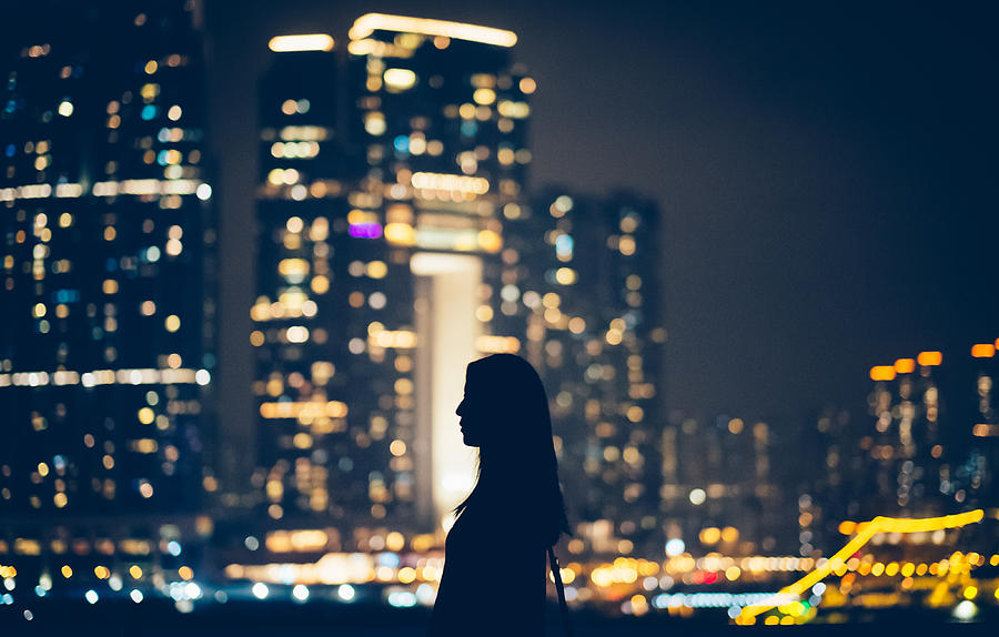Silhouette of woman looking away to cityscape Photograph by D3sign