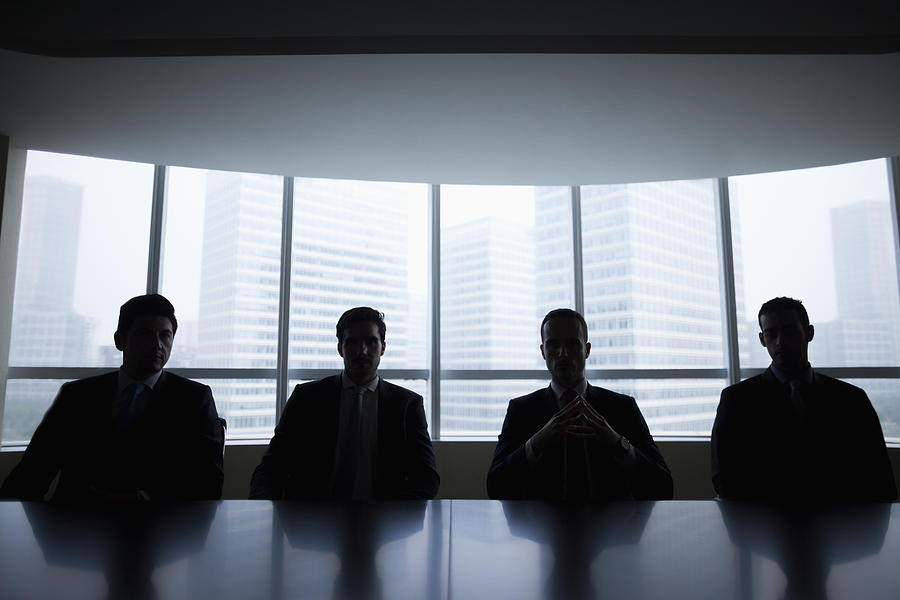Silhouette row of businessmen sitting in meeting room Photograph by FangXiaNuo