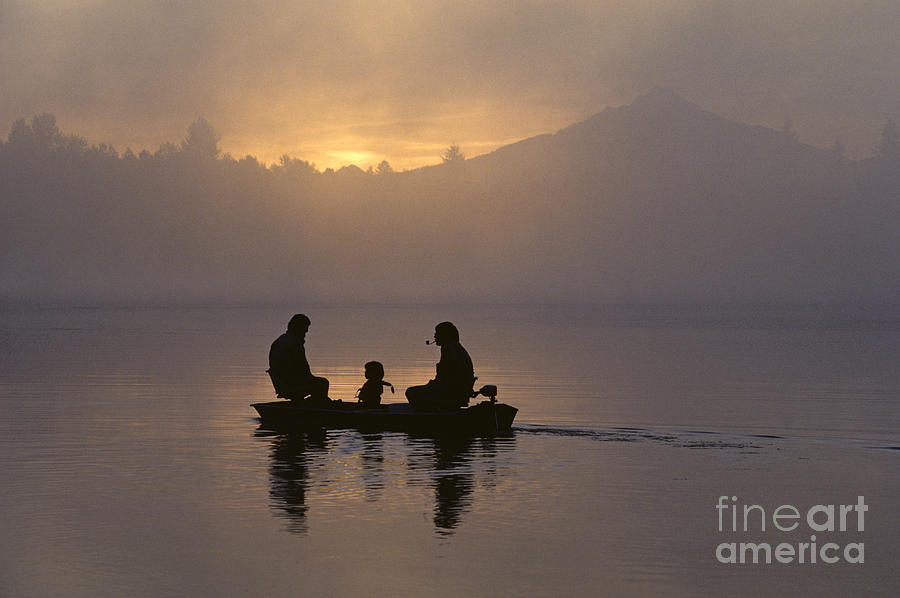 Silhouetted Family in small Boat Photograph by Jim Corwin