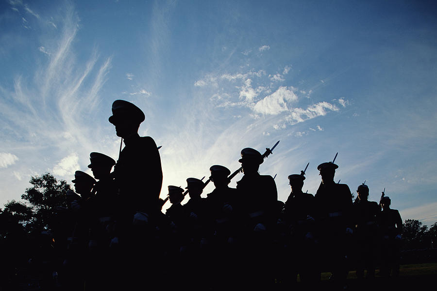 Silhouetted naval cadets marching in formation, low angle view Photograph by Paul Souders