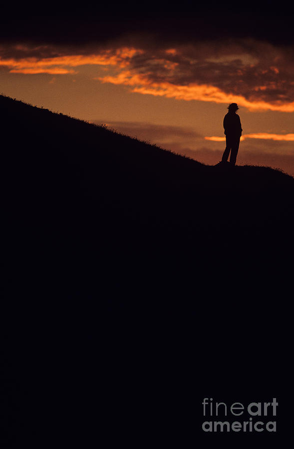 Silhouetted woman at sunset standing on bluff Photograph by Jim Corwin
