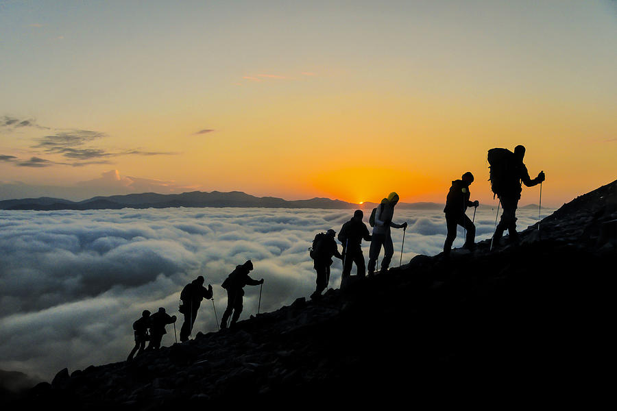 Silhouettes of hikers At Sunset Photograph by Guvendemir