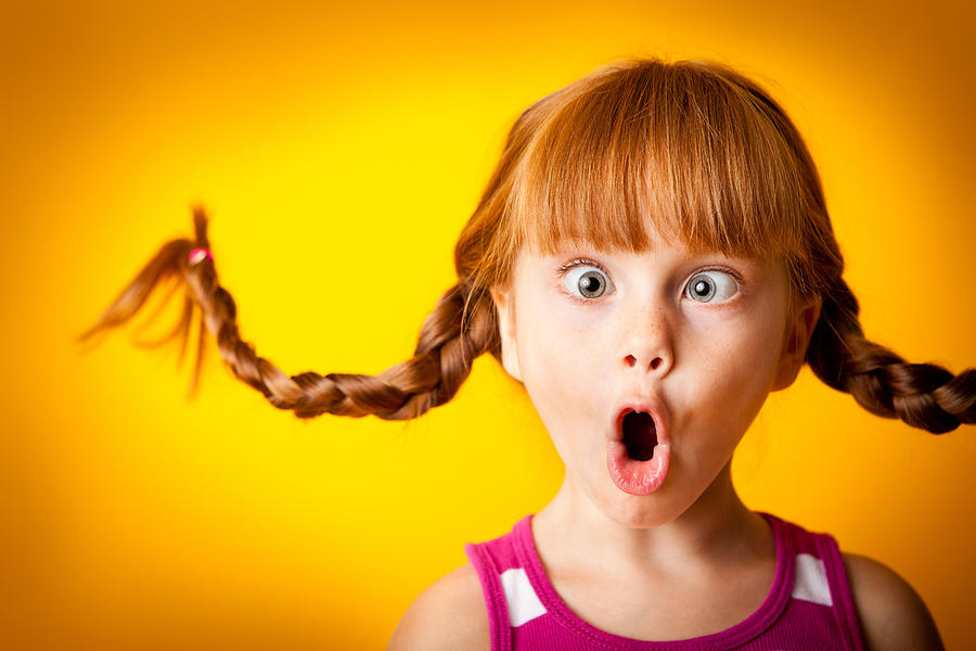 Silly, Red-Haired Girl with Upward Braids Making Crazy Face Photograph by Ideabug