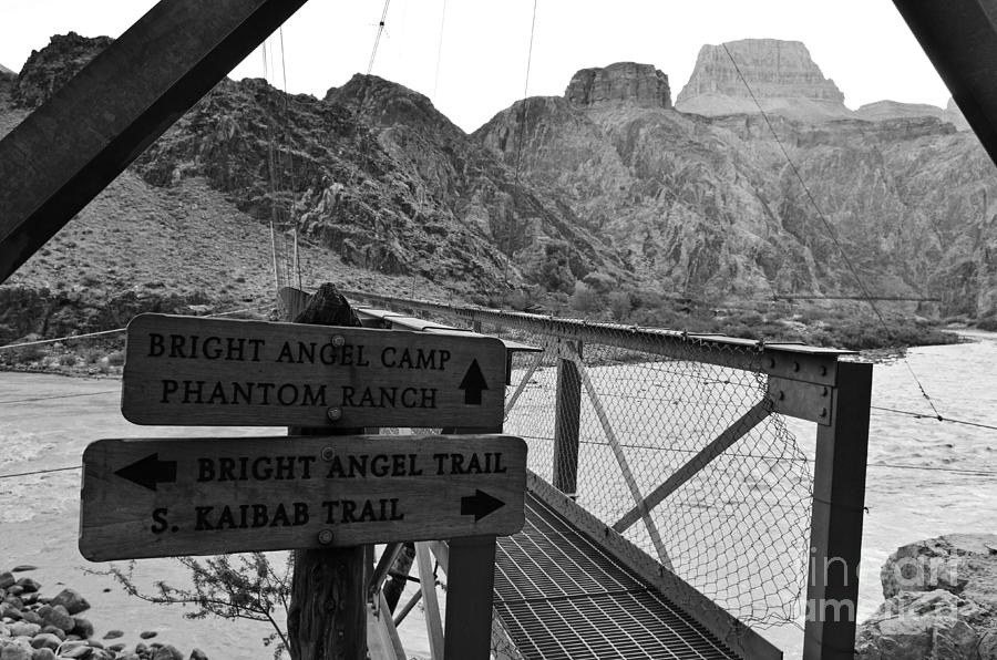 Silver Bridge Signs over Colorado River at bottom of Grand Canyon National Park Black and White Photograph by Shawn OBrien