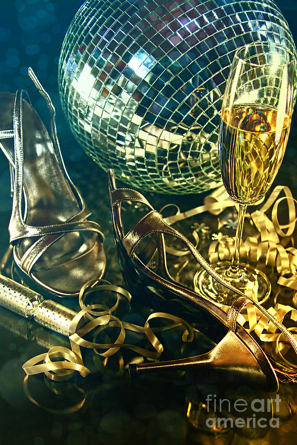 Silver party shoes on floor with champagne glass  Photograph by Sandra Cunningham