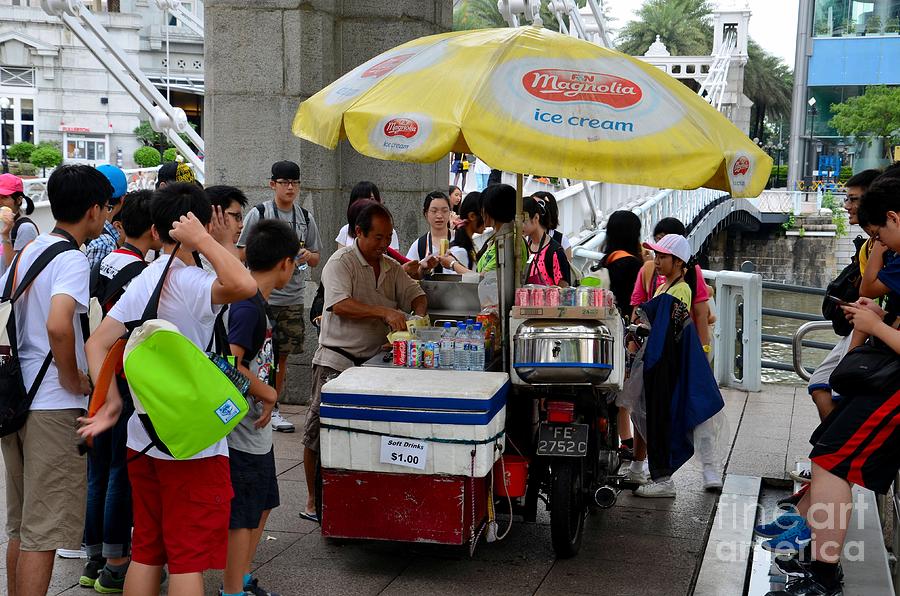 Singapore ice cream man and bicycle swamped by students Photograph by Imran Ahmed