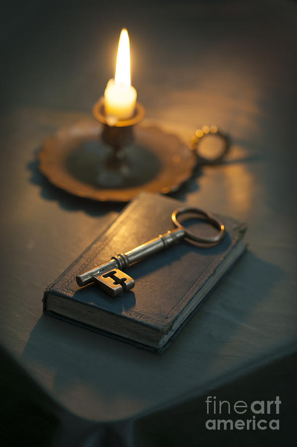 Single Golden Key On A Book By Candle Light Photograph by Lee Avison
