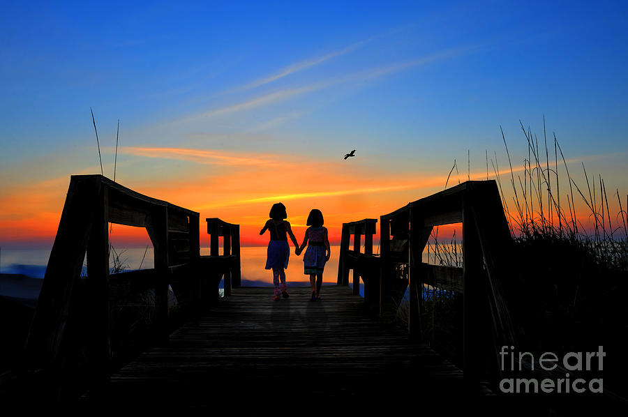 Sisters holding hands watching sunrise Photograph by Dan Friend